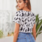 Round Neck Tie Front Cow Print Crop Top